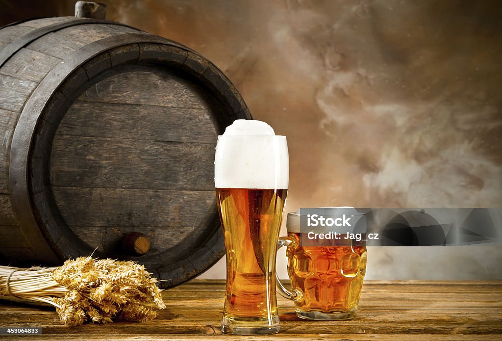 Beer still life Wooden keg with glasses of beer and blur background Alcohol - Drink Stock Photo