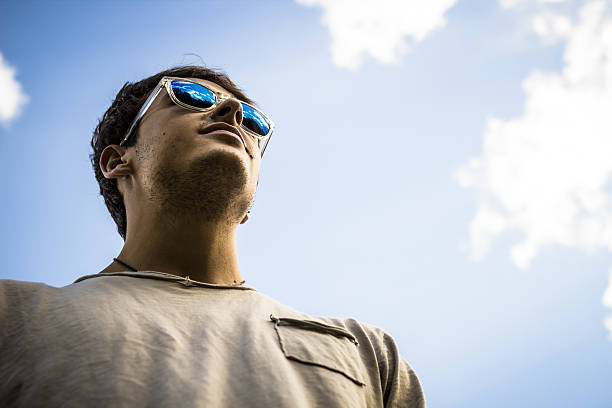 istock Young man wearing mirrored sunglasses with sky background 453068165