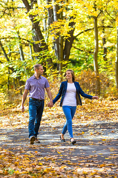 istock Young couple walking in park 453069263