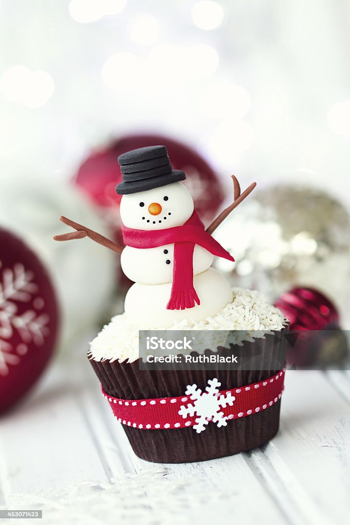 Snowman cupcake Cupcake decorated with a fondant snowman Snowman Stock Photo