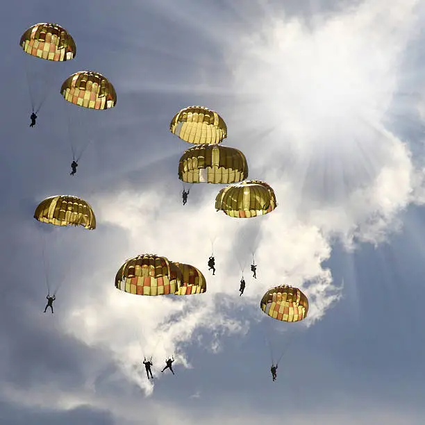 The skydivers on stormy sky.