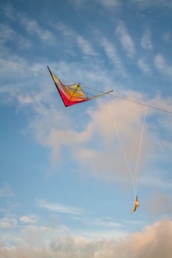 colorful kite tangled in Electrical wires against the evening sky