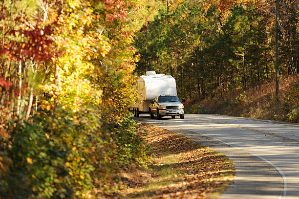istock Autumn road with recreational vehicle 453077823