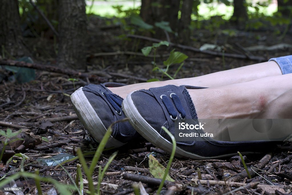 Woman legs in the forest Forensics and investigation girl legs in the forest Women Stock Photo