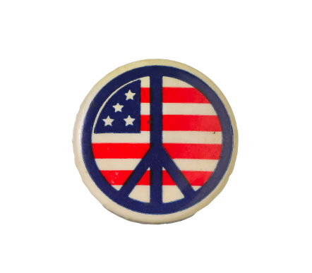 Isolation of vintage peace movement button with peace sign over US flag