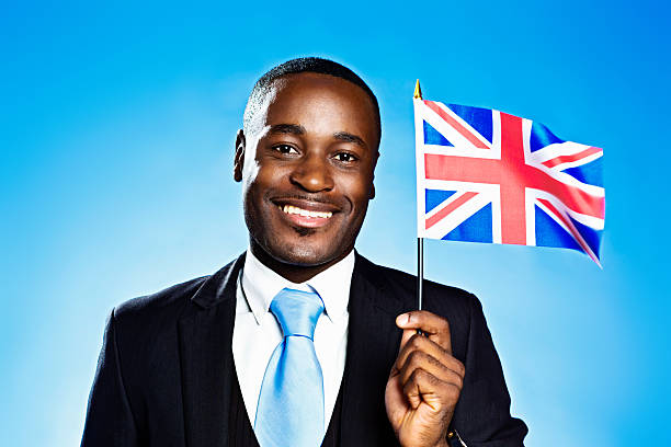 istock Happy British patriot waves the Union Jack 453081171