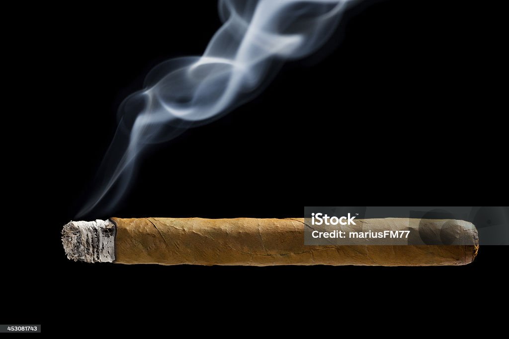 Cuban cigar Cuban cigar with smoke over black Cigar Stock Photo