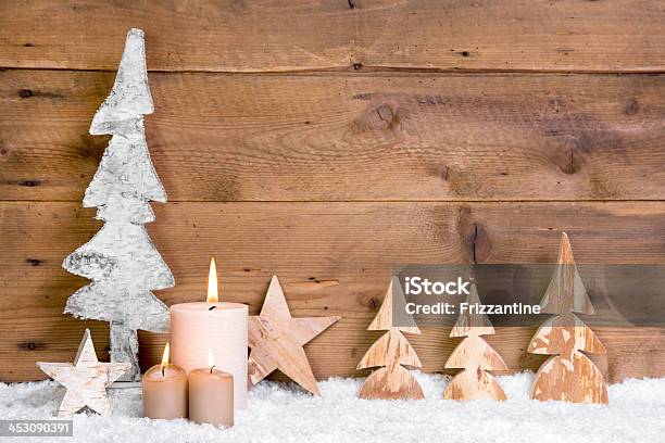 Wooden Rustic Christmas Decoration With A Candle And Snow Stock Photo - Download Image Now