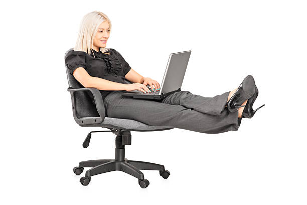 istock Woman sitting and working on a laptop 453094955