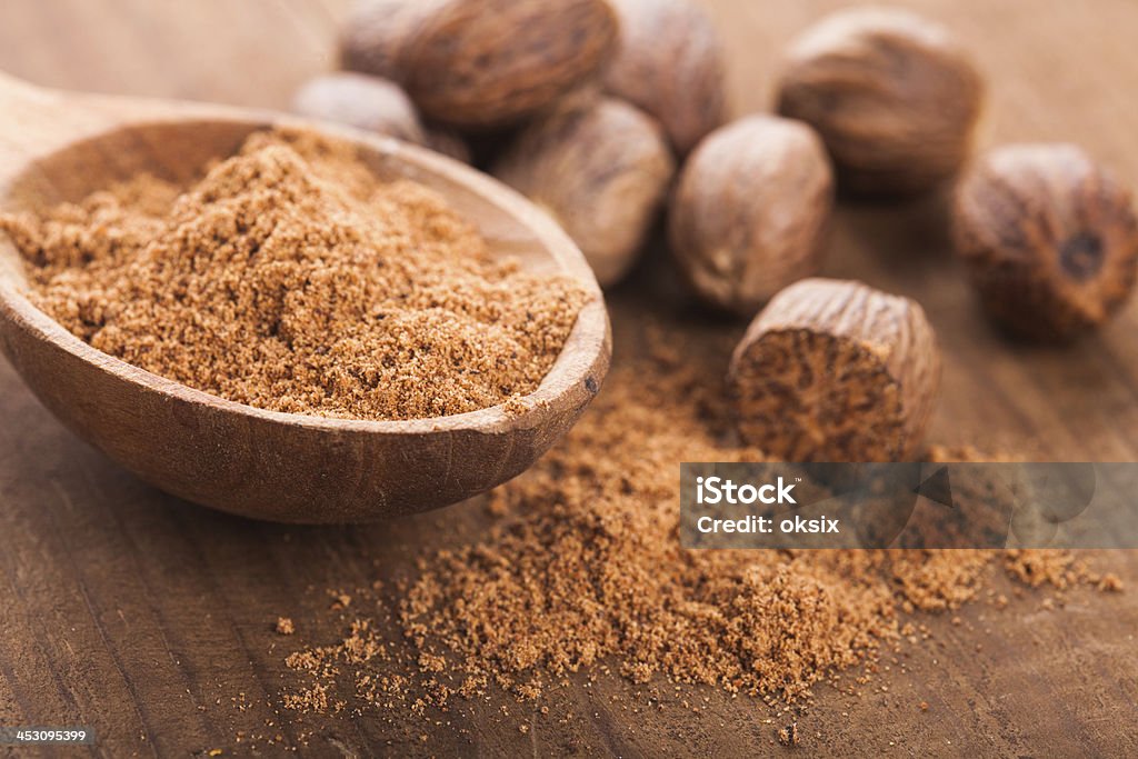 Ground nutmeg Ground nutmeg spice in the wooden spoon closeup Backgrounds Stock Photo