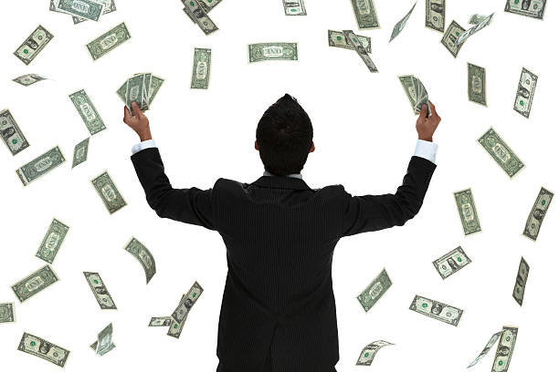 istock Raining money on a celebrating business man behind view 453095817