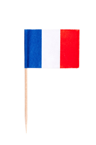 French paper toothpick flag. Nice paper texture. Isolated on white.