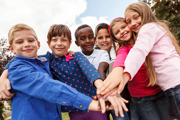 istock Multiracial school children putting their hands together 453100095