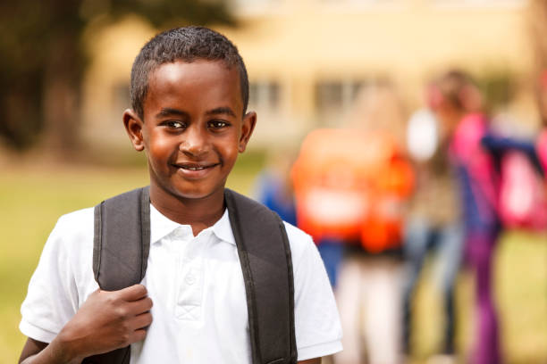 istock Happy schoolboy in front of the school 453100221