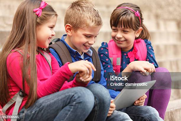 School Children Using Digital Tablet Outside Stock Photo - Download Image Now - Learning, Video Game, 8-9 Years