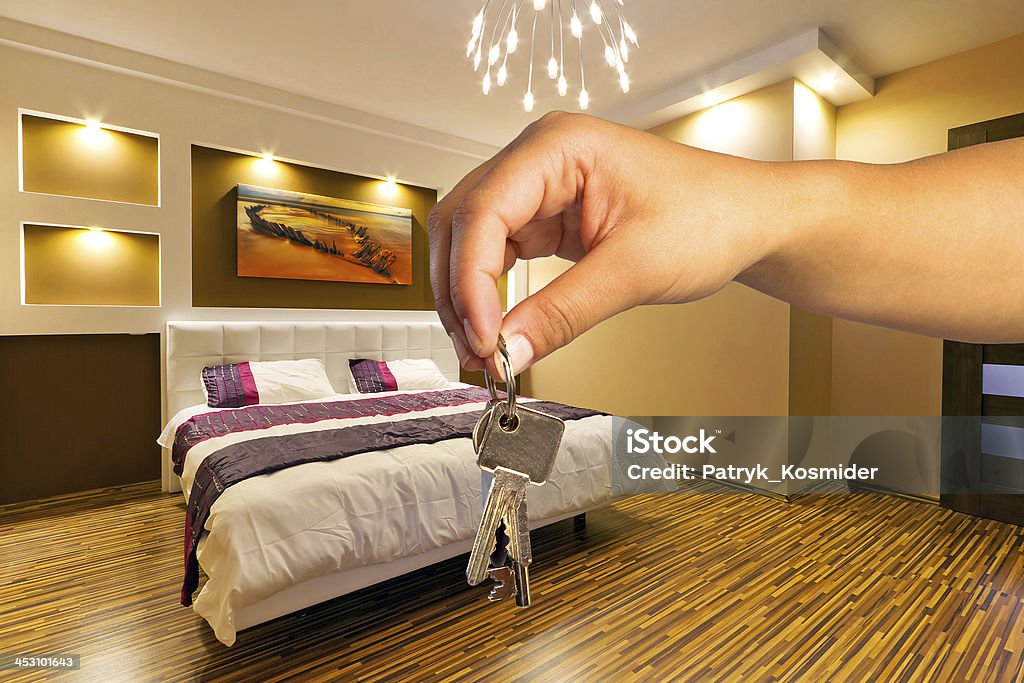 Keys to modern apartment Hand holding keys to new modern apartment Apartment Stock Photo