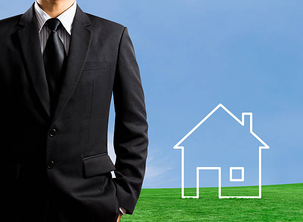 istock Man drawing a house in field 453102193