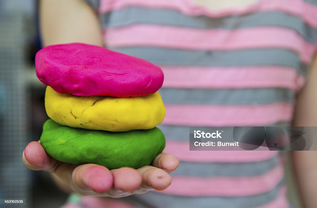 Colorful  play dough on hand Blue Stock Photo