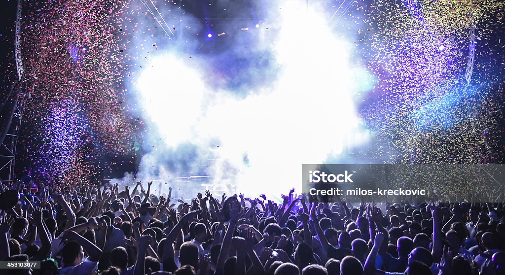 Open air party in the nighclub Live music event with lots of light, smoke and confetti Crowd of People Stock Photo