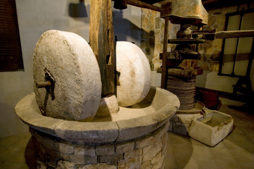 Ancient olive oil production machinery, stone mill and mechanical press