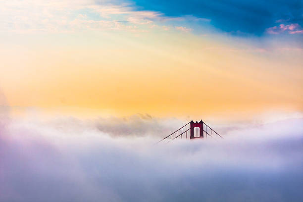 Golden Gate Bridge above Clouds after sunrise in San Francisco