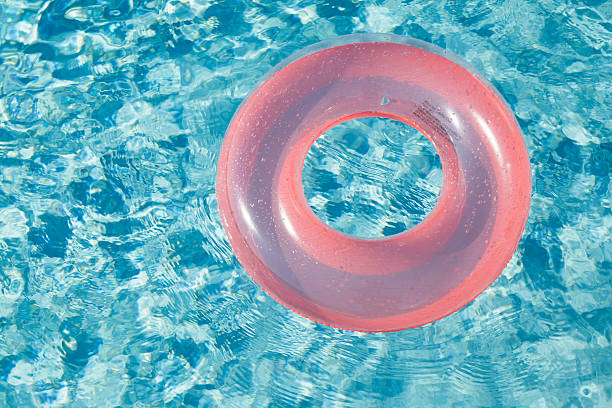 istock Orange Swim Ring Floating on Pool Water 453122347