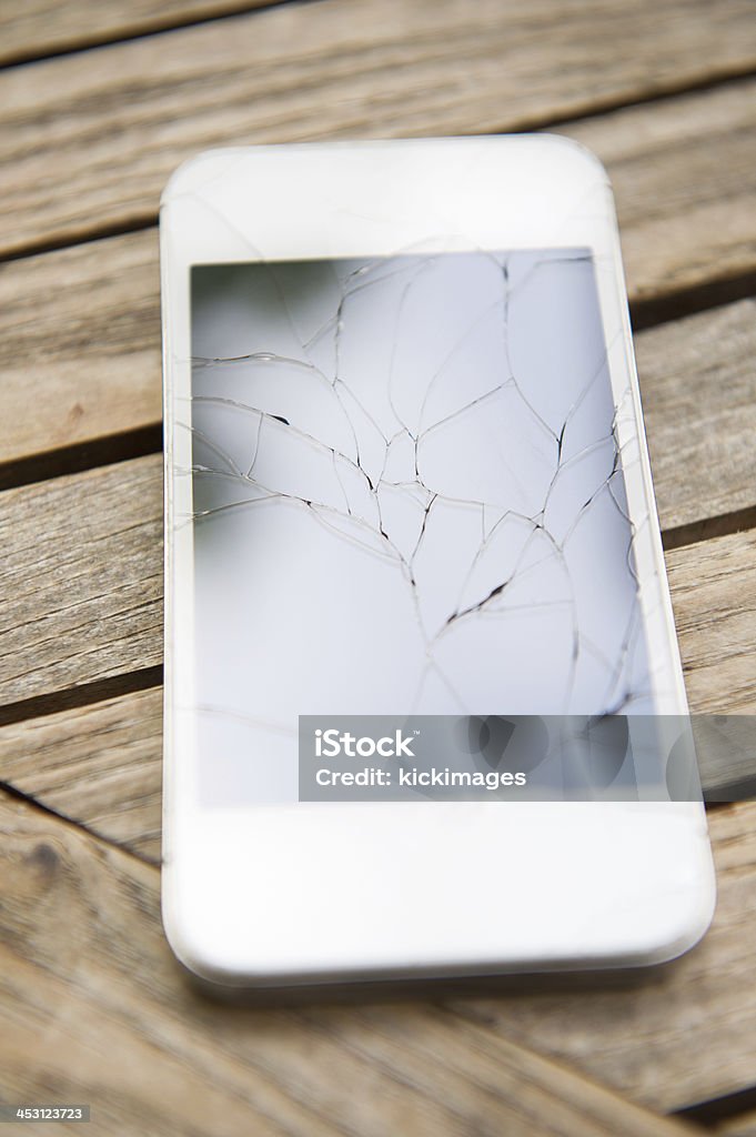 Cracked Smart Phone Close-up of a cracked screen smart phone. Bright Stock Photo
