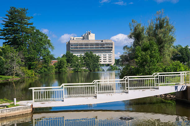 UMass-Amherst Campus Center and Hotel The University of Massachusetts-Amherst Campus Center and Hotel are reflected in the waters of the Campus Pond. university of massachusetts amherst stock pictures, royalty-free photos & images