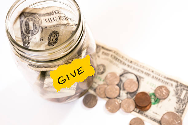 istock Volunteerism:  Money Jar with coins, dollar bills.  Give. Donation, fundraiser 453123981
