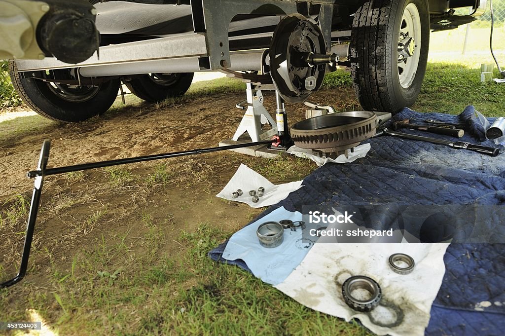 Wheel service on recreational vehicle Repairing or servicing the bearings and brakes on a recreational vehicle travel trailer. Repairing Stock Photo