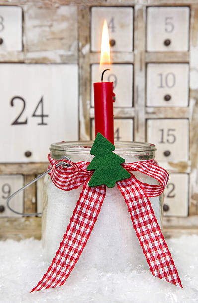istock One red advent candle with a checkered bow for christmas 453128013