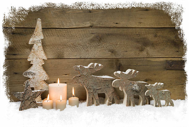istock Three christmas mooses wearing santa hats - wood background. 453132709