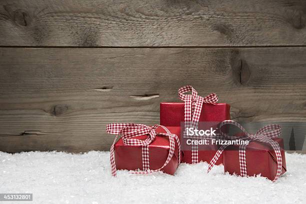 Red Christmas Presents With Checkered Bows On Wooden Background Stock Photo - Download Image Now