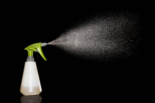 Bottle water sprayer Bottle water sprayer isolated on black background spraying water stock pictures, royalty-free photos & images