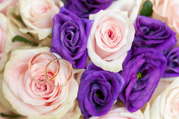 istock wedding rings  groom and  bride on a bunch of flow 453136921