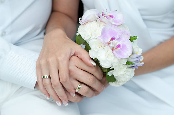 istock Wedding bouquet with hands and rings 453141141