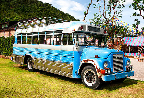 Abandoned old bus in a green field stock photo