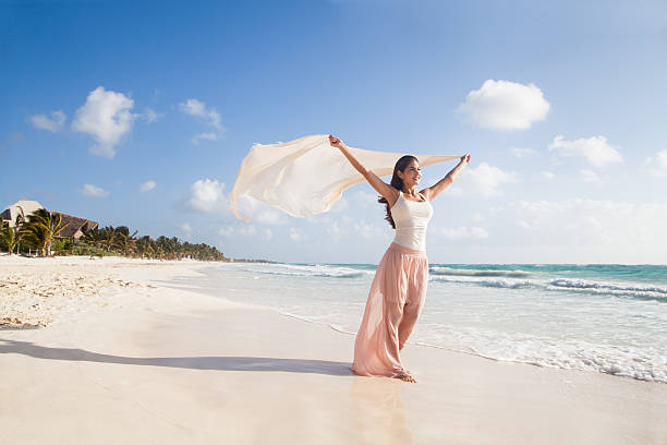 mulher bonita feliz andando na praia - wind scarf women people - fotografias e filmes do acervo
