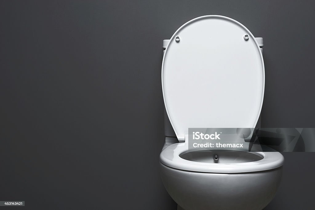 Toilet Plain white toilet on grey background. Toilet Stock Photo