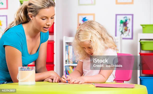 Little Caucasian Girl And Her Carer During Artwork Stock Photo - Download Image Now - 20-29 Years, 30-39 Years, 4-5 Years