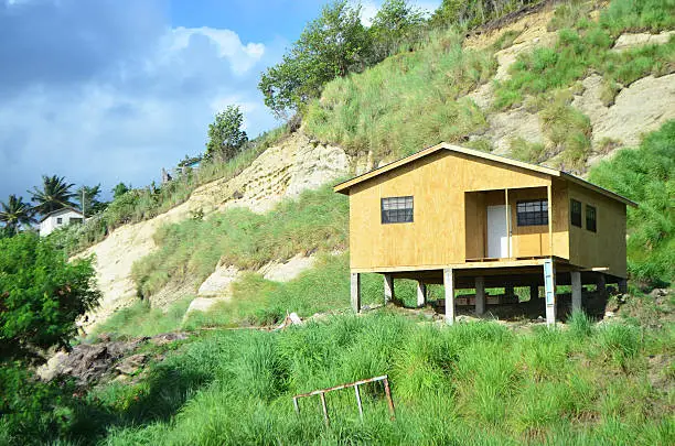 unfinished plywood house on rocky hill