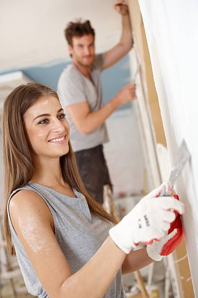 istock Attractive woman renovating house smiling 453145473