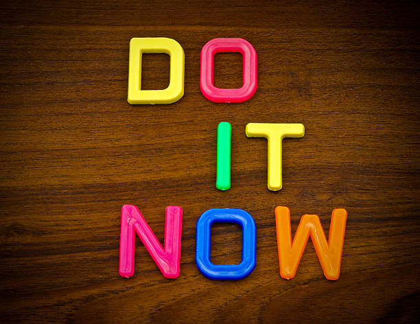 istock Do it now in colorful toy letters on wood background 453147763