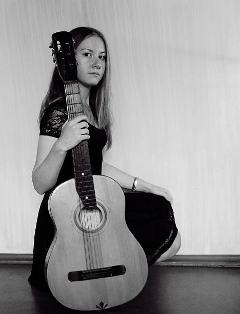 istock Young woman holding a guitar 453147835