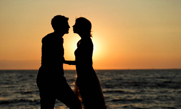 istock Couple at the sea shore in dusk. 453155837