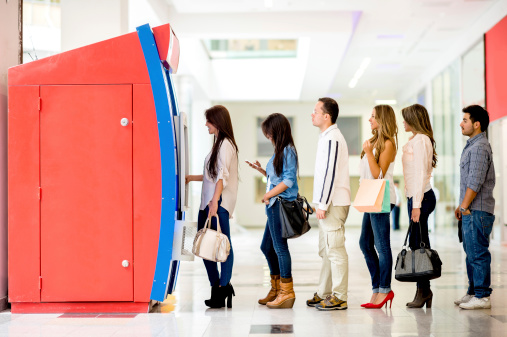 Group of people in the line to withdraw money from the ATM