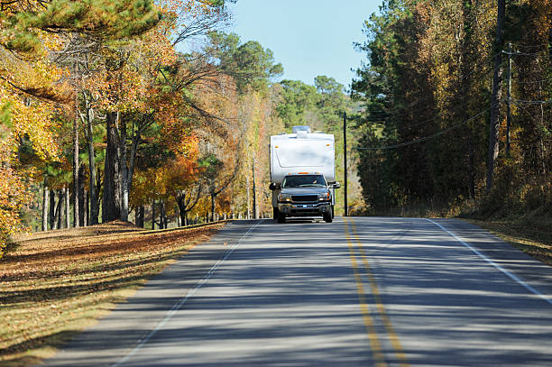 istock Recreational vehicle being towed down autumn road 453156965
