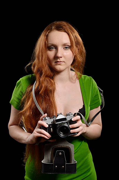 istock Pretty woman with a vintage camera 453158247