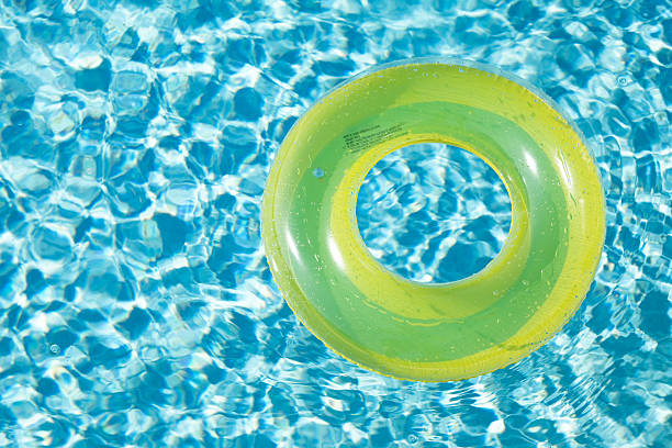 istock Yellow Swim Ring Floating on Pool Water 453158415