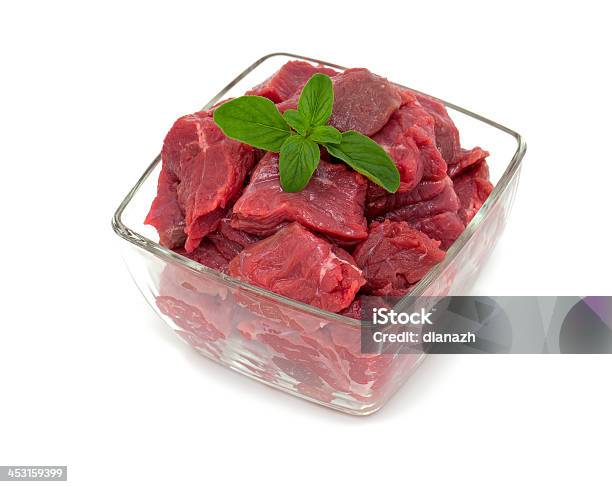 Pieces Of Fresh Beef In A Glass Bowl With Oregano Stock Photo - Download Image Now - Glass - Material, Meat, Bowl